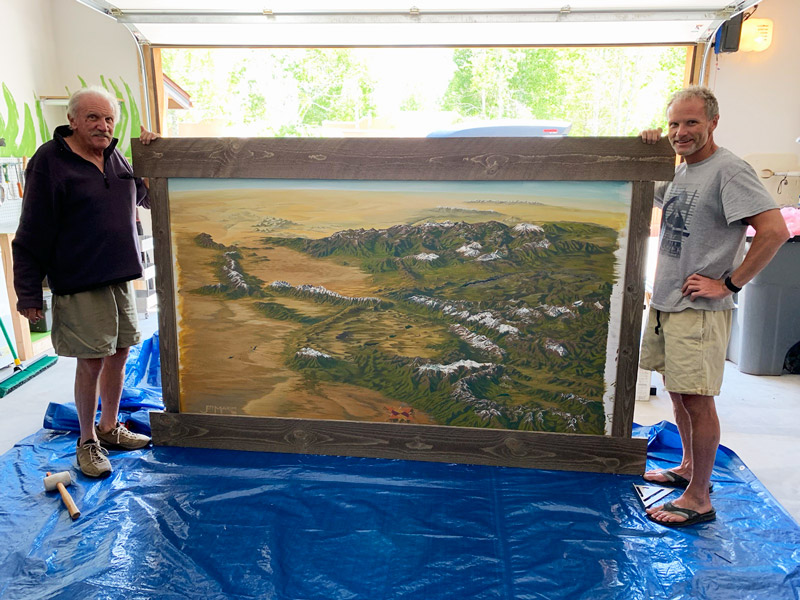 Photo of Shane Jordan and his father holding the original artwork that inspired the Colorado Fourteeners poster